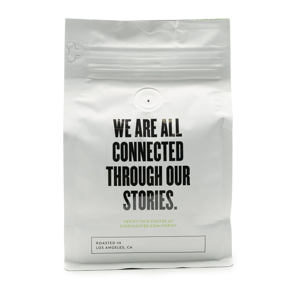 This image shows the back of our Single Origin Decaf Mexico Coffee bag, which reads “ We are all connected through our stories.” 
