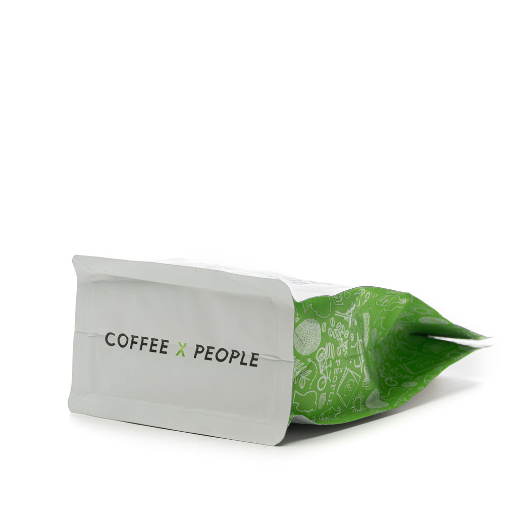 This image shows the bottom of our Single Origin Decaf Mexico Coffee, which reads “ coffee x people,” serving as a reminder of our mission to connect people over coffee. 