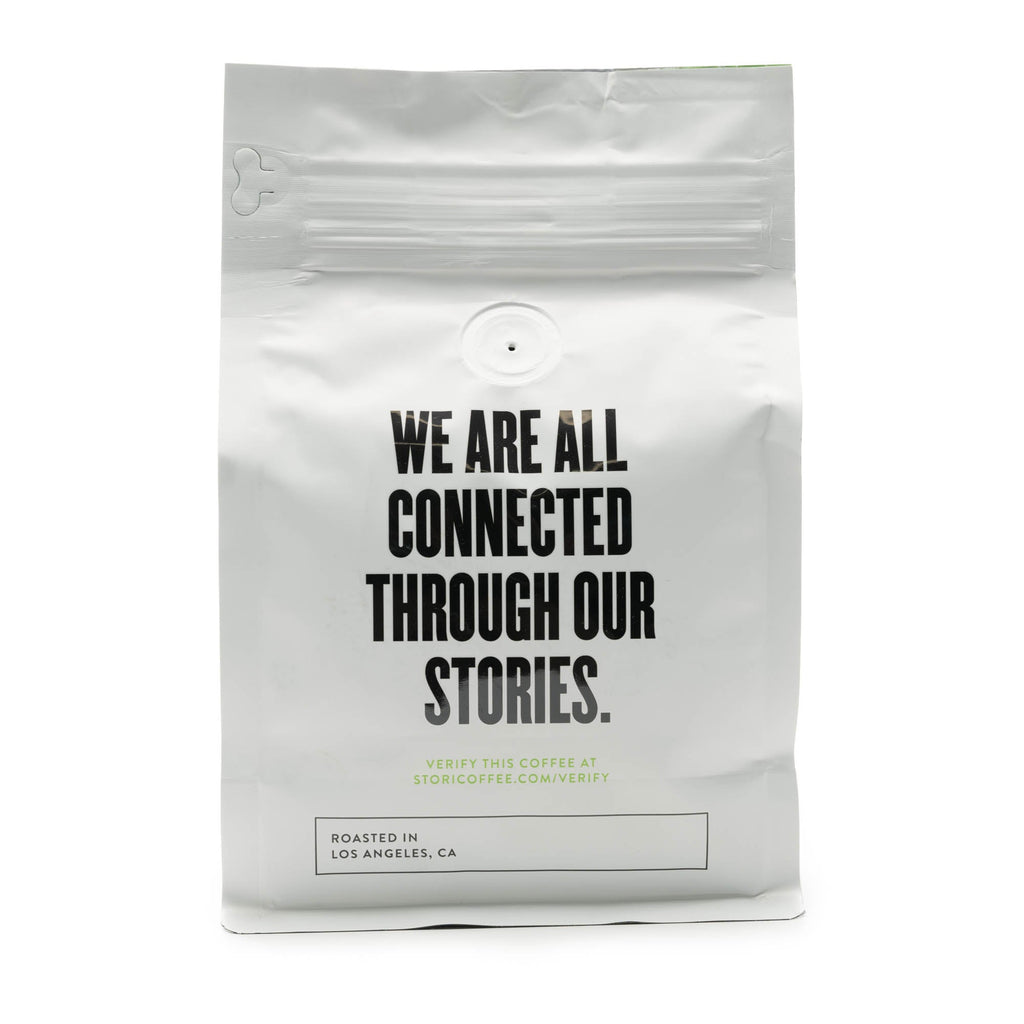 This image shows the back of our Single Origin Rwanda Coffee Bag, which reads “ We are all connected through our stories.”